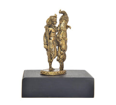 Rear view of Lord Kartikeya Murugan and peacock idol statue on dark base