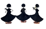 Black iron folk musician figurines with wide flared dresses and small circular bases