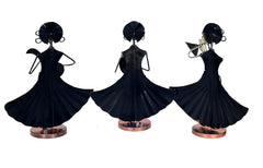 Black iron folk musician figurines with wide flared dresses and small circular bases