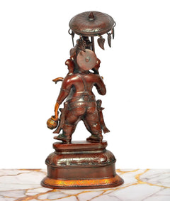 Back view of Ganesha sculpture holding an umbrella, ornate base details visible