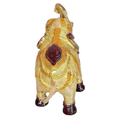 Golden brass elephant showpiece, back view with ornate saddle and raised head ornament