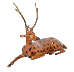 Brass sitting deer figurine, side view with raised front leg and black-spotted fur
