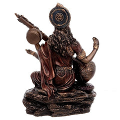 Saraswati resin idol side view with circular halo emblem and seated pose