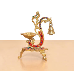 Brass peacock diya with hanging bell, multicolor jeweled details, pedestal base and oil bowl