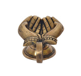 Brass hand-shaped diya with folded-hands detail, oil-wick lamp on pedestal base