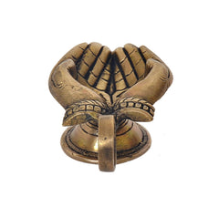 Brass hand-shaped diya with folded-hands detail, oil-wick lamp on pedestal base