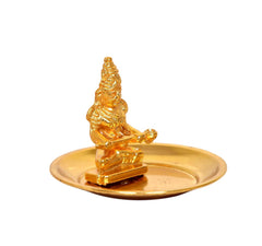 Brass goddess idol on round plate, raised hands and skirt details, angled view