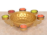 Gold urli decorative bowl with six tea lights and peacock-style side cutouts