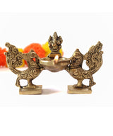 Brass Ganesha diya lamp with peacock duo holders, twin-wing design and flame