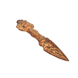 Brass phurba dagger pendant with etched hilt and elongated pointed blade, side view
