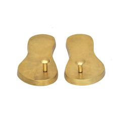 Pair of brass khadau pooja padukas, rounded form, upright pegs