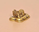 Brass Baby Ganesh statue, golden finish, angled view showing detailed facial features
