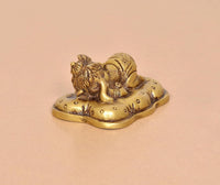 Brass Baby Ganesh statue, golden finish, angled view showing detailed facial features