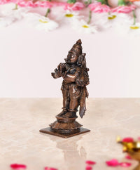 Copper Garuda idol statue, side view with raised hands and flowing wings, 3.5 in