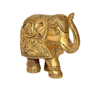 Brass elephant figurine, side close-up of face and trunk with decorative saddle carvings