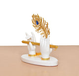 Side view of white resin Krishna hands with gold flute, blue peacock ornament, circular base