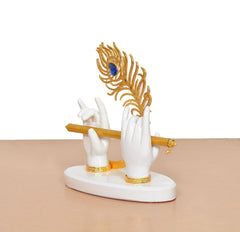 Side view of white resin Krishna hands with gold flute, blue peacock ornament, circular base