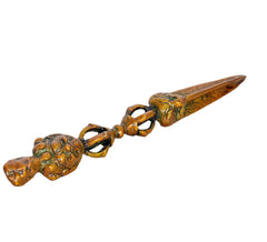 Close view of multicolor brass phurba dagger pendant with pointed blade and rings