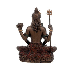 Rear view of Shiva murti statue, trident and drum in hands, seated on lotus base