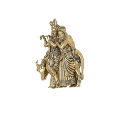 Brass Radha-Krishna with cow sculpture, three-quarter view; ornate headgear and jewelry