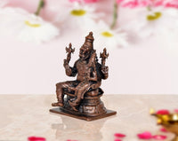 Side view copper Lakshmi Narasimhar idol, seated on pedestal with detailed ornaments