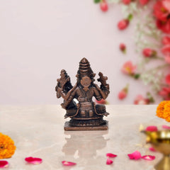Copper Lakshmi Narasimha idol, angled view showing seated posture and crowns, 2 inch