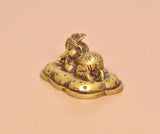 Brass Baby Ganesh statue, golden tone, side view of sleeping child and base