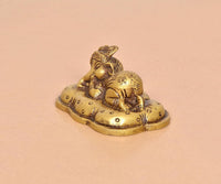 Brass Baby Ganesh statue, golden tone, side view of sleeping child and base