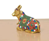 Brass Nandi statue in profile view, multicolor jeweled saddle and head ornaments