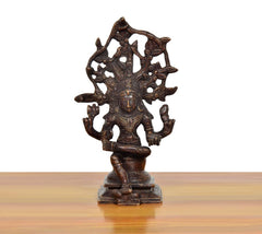 Brass Dakshinamurti Shiva murti front view, intricate ornamented backdrop
