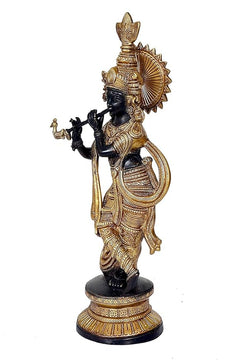 Lord Krishna metal sculpture holding flute, profile view with engraved gold patterns