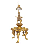 Brass peacock oil lamp stand with tall central stem over 15 diya bowls.