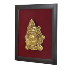 Brass Maa Durga face idol relief in dark square frame, angled view