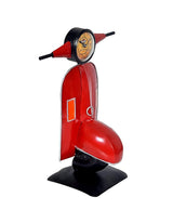 Angled view of red scooter collectible table topper with clock face and black stand