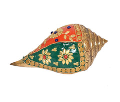 Decorative brass shankh with red-orange top and green panel, gold details