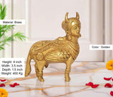 Brass Kamdhenu cow statue, golden; 4 in height, 3.5 in width