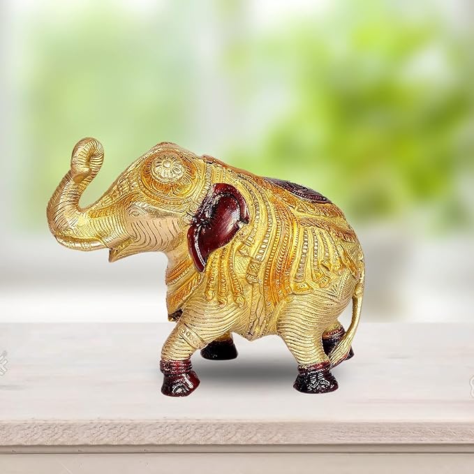 Golden brass elephant showpiece with raised trunk and red accents, detailed body