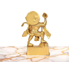 Brass Hanuman figurine from back/side, rounded head and raised weapon handle