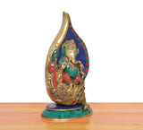 Brass Ganesha conch murti, angled view, multicolor inlay on blue mosaic conch