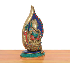 Brass Ganesha conch murti, angled view, multicolor inlay on blue mosaic conch