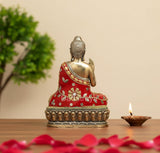 Buddha statue in gold with red embroidered robe, raised blessing hand