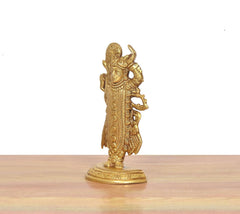Shreenathji brass statue side view, intricate detailing and round pedestal base
