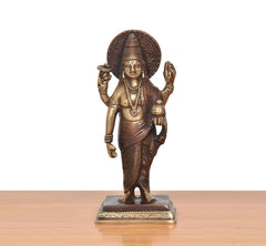 Brass Dhanvantri statue facing forward, halo behind head, ornate jewelry details