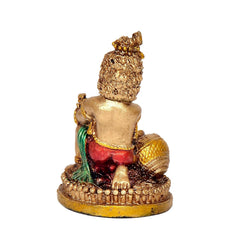 Resin Krishna idol holding butter pot, red dhoti, green scarf, gold textured base