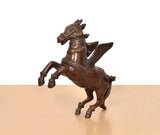 Brass flying horse with wings, three-quarter view, carved face and flowing tail
