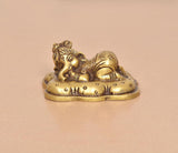 Brass Baby Ganesh statue in golden finish, close view of head and curled body