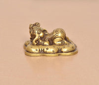 Brass Baby Ganesh statue in golden finish, close view of head and curled body
