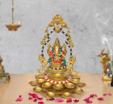 Brass Ganesh diya showpiece with 21 oil lamps, ornate arch and painted accents