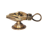Brass hand-shaped oil lamp diya on round pedestal base with loop handle ring