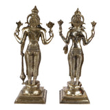 Brass Lakshmi and Vishnu statues, standing with multi-hand symbols, on square pedestals
